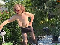 Mature wife gardens outdoors in sheer black pantyhose before her horny husband fucks her hard against the tree.